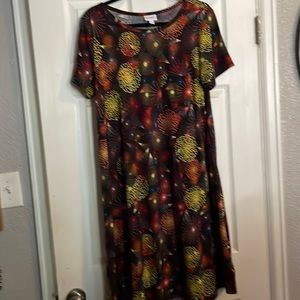 L Carly hi lo hem. Black with prints . 95% polyester 5% spandex.